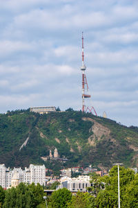 Tower amidst buildings in city against sky