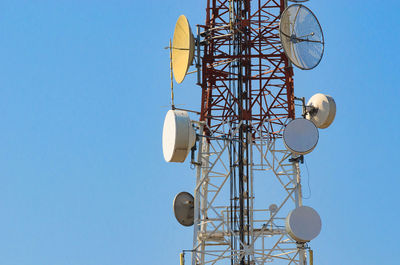 Low angle view of communications tower against clear sky