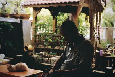 Man sitting on table by building