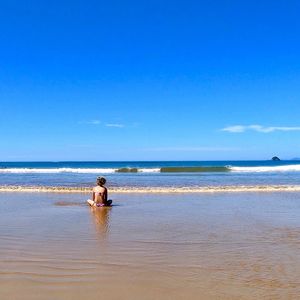 Man in sea against sky