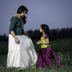 Rear view of woman standing on field