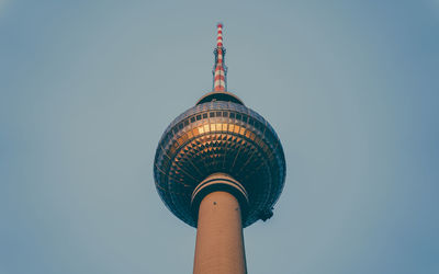 Low angle view of communications tower against sky