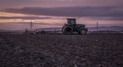 Vintage car on field during sunset