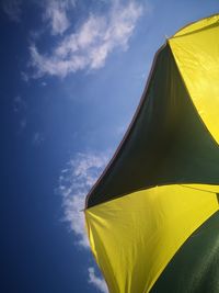 Low angle view of yellow flag against sky