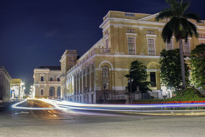 Light trails on street amidst buildings in city at night teatro sauto matanzas cuba 