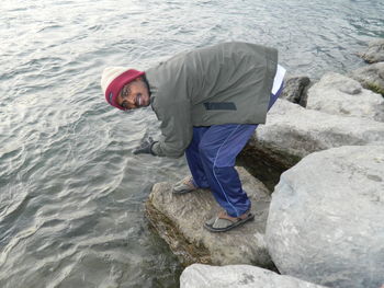 Full length of man climbing on rock