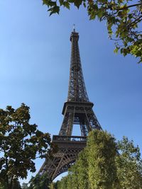 Low angle view of eiffel tower against clear blue sky