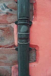 Close-up of pipe on brick wall
