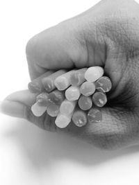 Close-up of human hand against white background