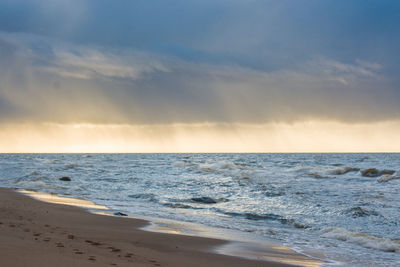 Scenic view of sea against cloudy sky