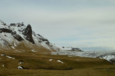 Scenic view of snow covered mountains against sky