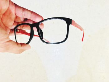 Close-up of human hand holding sunglasses