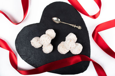 High angle view of heart shape made on white table