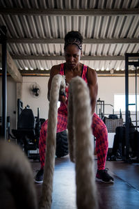 Portrait of young man exercising in gym