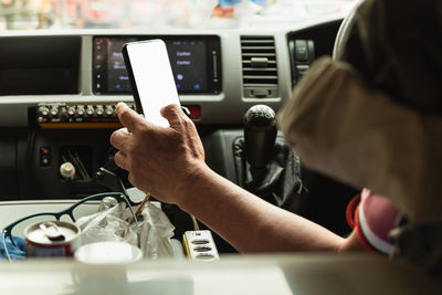 Midsection of man using mobile phone