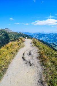 Scenic view of landscape against blue sky