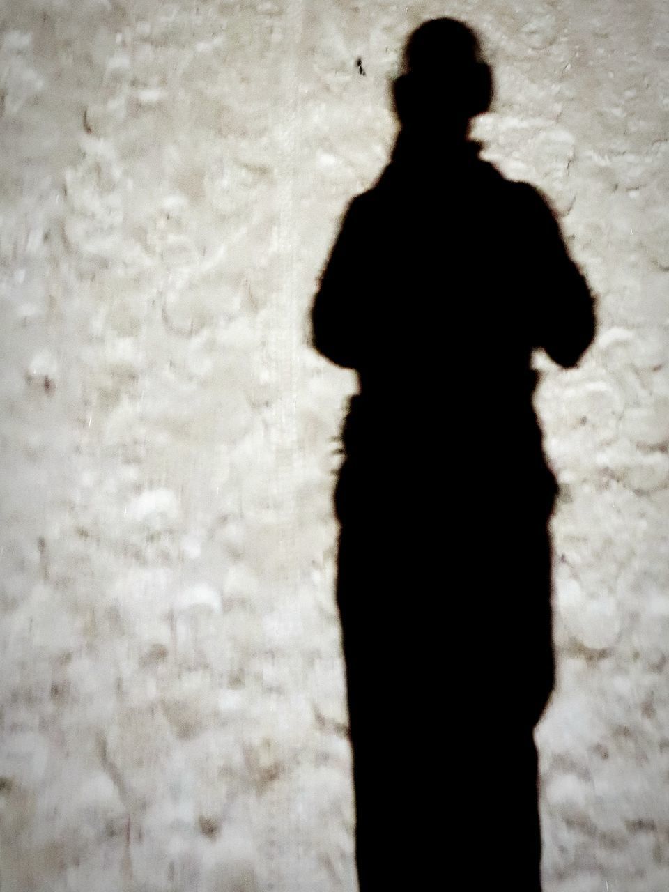 SILHOUETTE MAN STANDING ON WALL