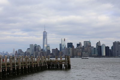 View of buildings in city against cloudy sky