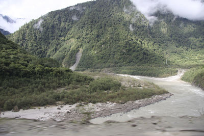 Scenic view of river flowing through mountains