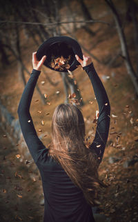 Woman throwing leaves