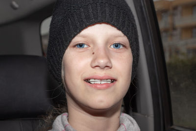 Portrait of smiling young woman in car