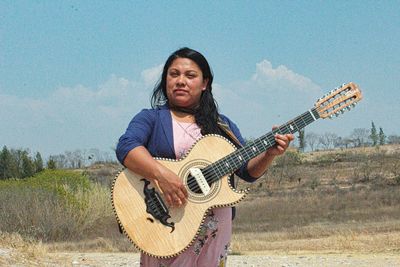 Full length of a man playing guitar