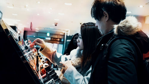 Side view of young woman using smart phone