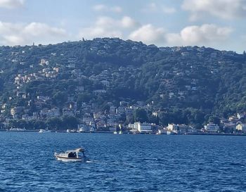 Scenic view of sea by city against sky