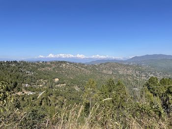 Scenic view of mountains against clear blue sky