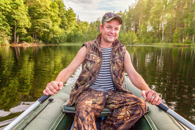 Portrait of smiling mid adult man in boat