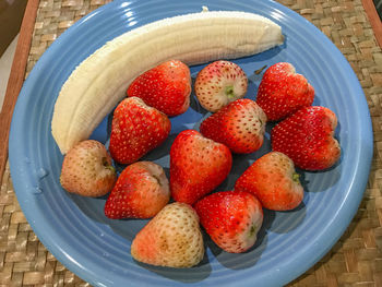 High angle view of strawberries in bowl on table