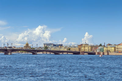 Panoramic view of buildings against cloudy sky