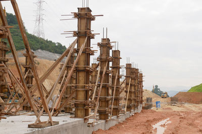 Construction site by sea against sky