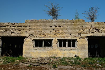 Abandoned building against clear sky