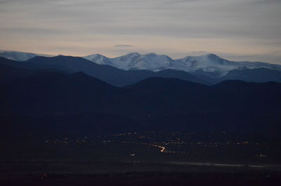 Scenic view of silhouette mountains against sky at sunset