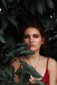 Portrait of young woman with leaves