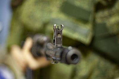 The barrel of an assault rifle. the weapon in the hands. firearms in combat condition. 