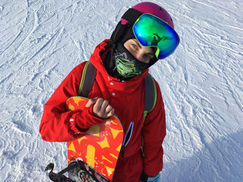 Woman wearing ski goggles against mountains during winter