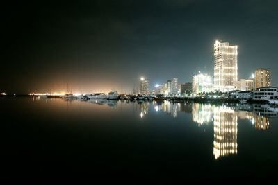 Illuminated city at waterfront