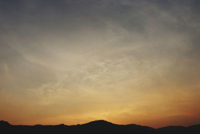 Low angle view of silhouette mountains against sky during sunset