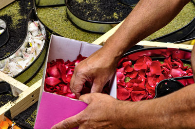 Low section of man holding flowers