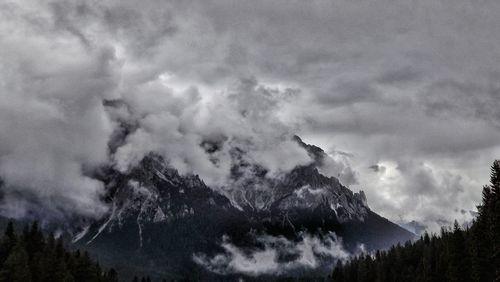 Scenic view of mountains against cloudy sky