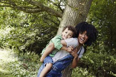 Mother giving a piggyback ride to her son