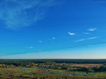 Scenic view of field against blue sky