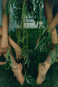 Low section of woman standing on field