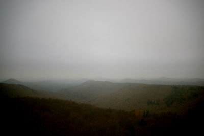 Scenic view of mountains against cloudy sky