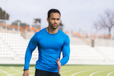 Determined male athlete running outdoors