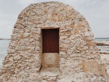 Built structure at beach against sky