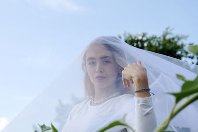 Portrait of woman against sky