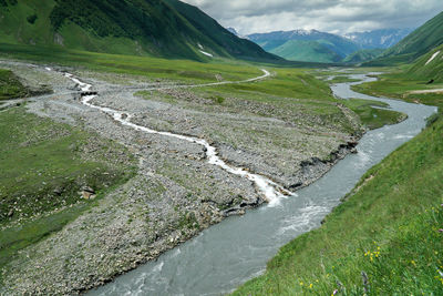 Scenic view of terek river amidst mountains